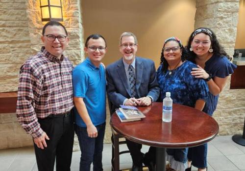 Connor with His Father (left), a Book Author, his Mother (second from right) and Sister