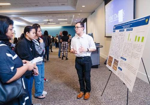 Biology Major Connor Hester Explaining His Polystyrene Degradation Research