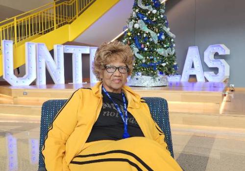 Anna Pedford Relaxing in Front of the Student Center Christmas Tree After Completing Her Final Senior Project