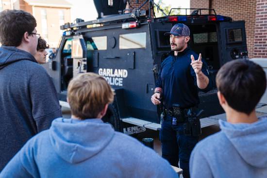 police officer talking with students