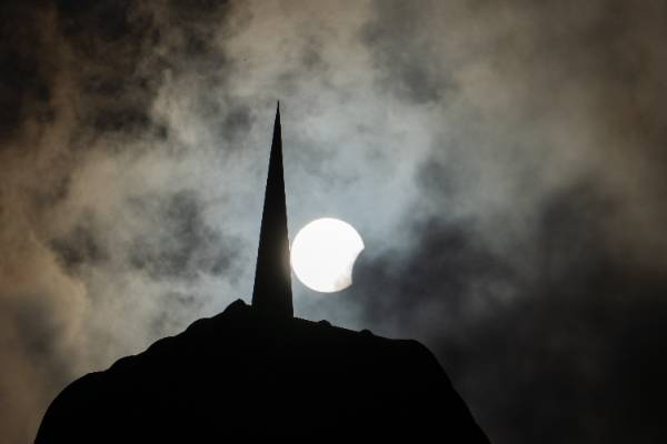 An Eerie View of the Sun, Clouds and Building Before the Moon Blocked the Sun on April 8, 2024