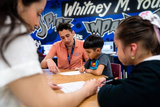 A Teacher Works with Students in a Dallas ISD Elementary School Classroom