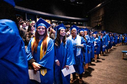 graduates wait to walk the stage at commencement