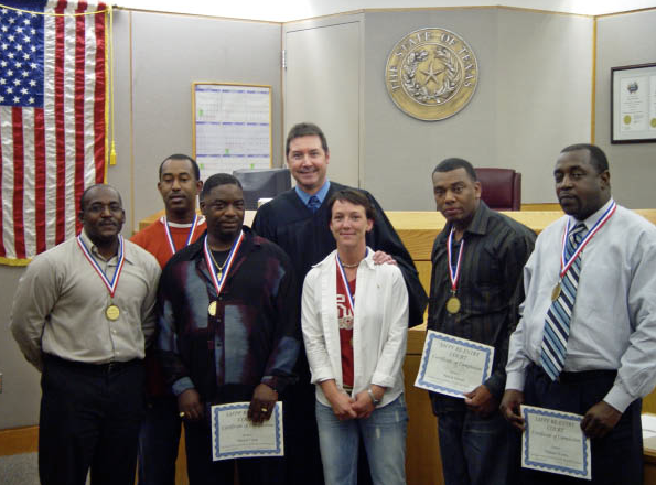 Judge Robert Francis with Graduates of a Drug Probation Program That Returns Offenders to the Community After a Short Time in Custody (Source: Reentry Court Solutions)