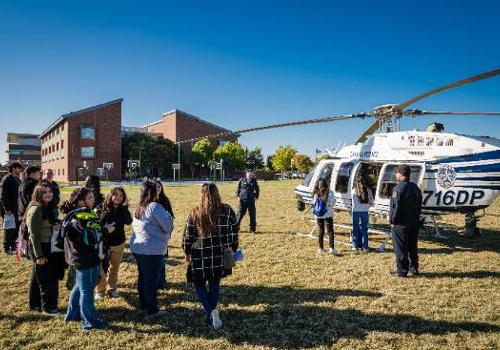 students standing near a law enforcement helicopter