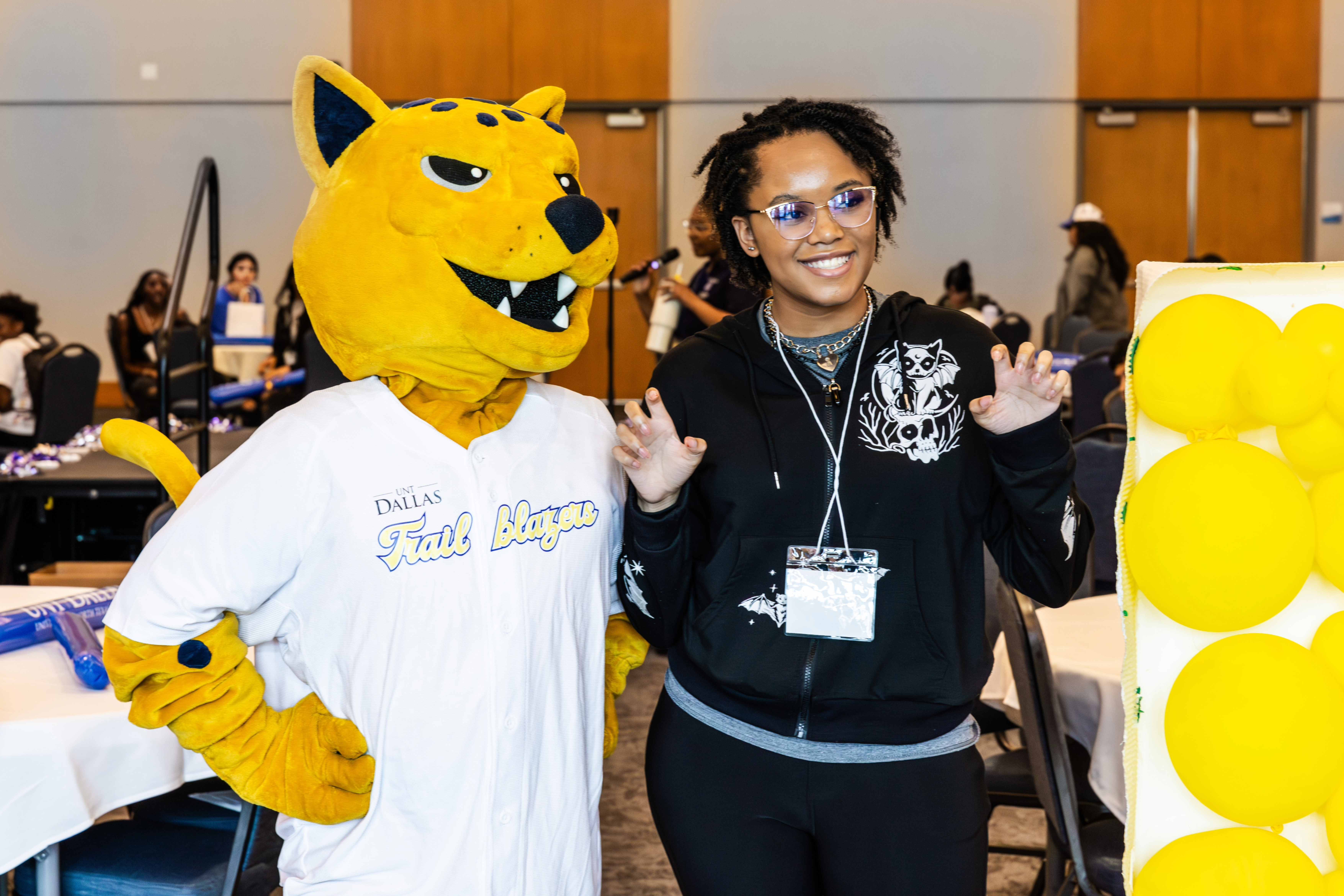 Student taking a picture with Jax