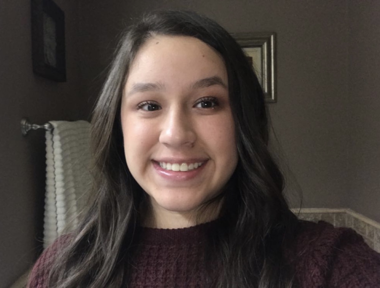 valeria in deep red knit shirt smiling