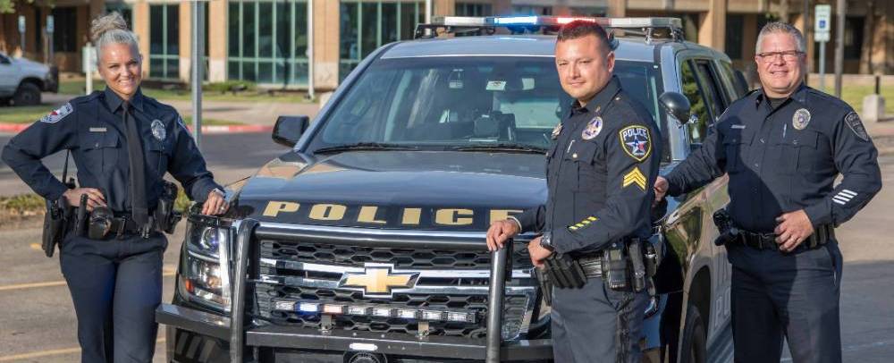 officers with car outside station